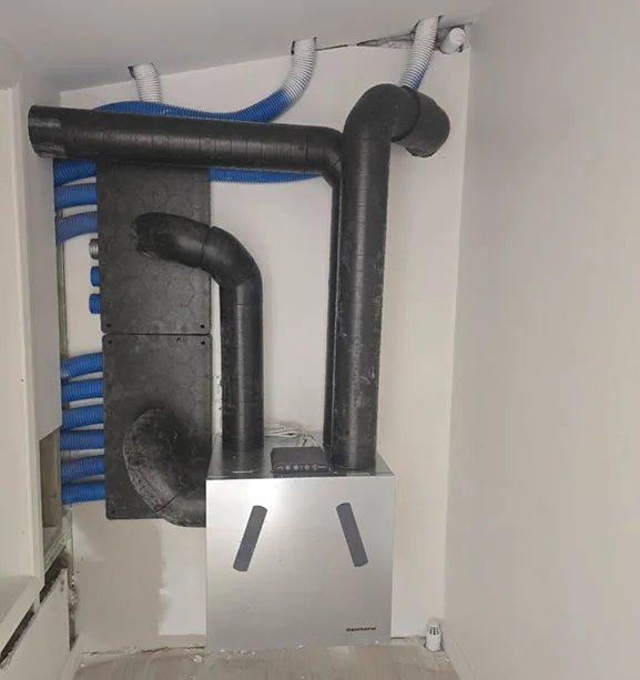 Insulated ducting connected to a heat recovery ventilation unit in a cupboard